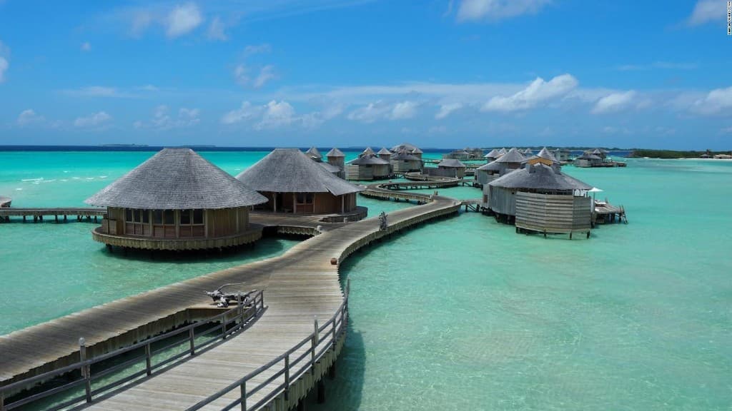 Overwater bungalows along a curved boardwalk