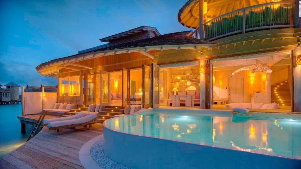 Overwater villa illuminated at dusk