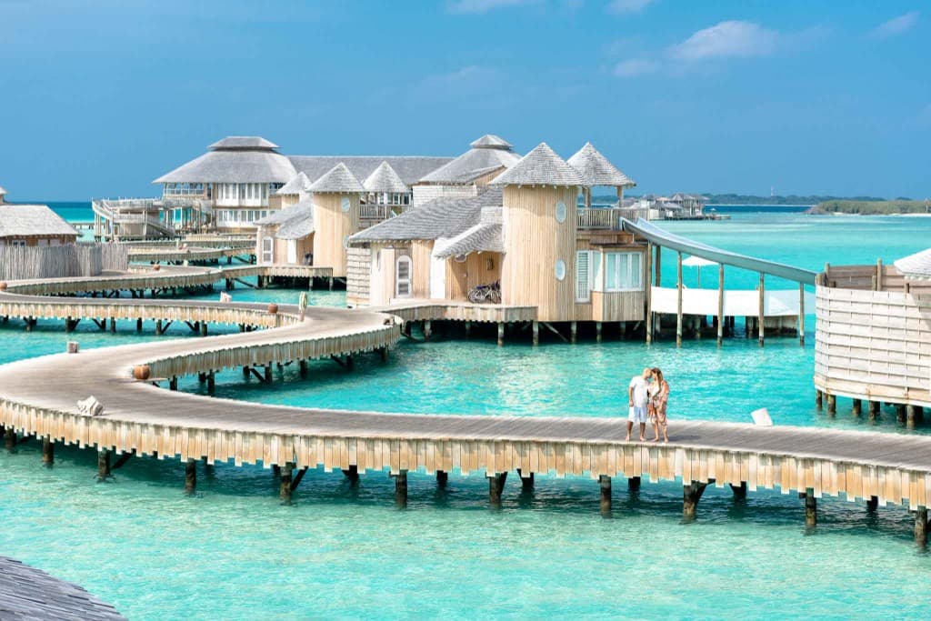A couple walking an overwater boardwalk