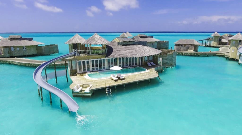 Overwater villa with private slide in a Maldivian lagoon