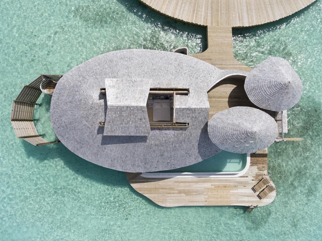 Aerial view of an overwater villa and lagoon