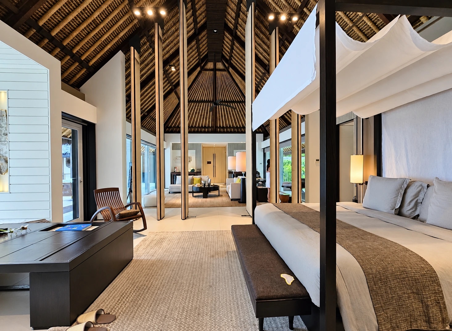 Villa bedroom beneath a high timber ceiling at Cheval Blanc Randheli