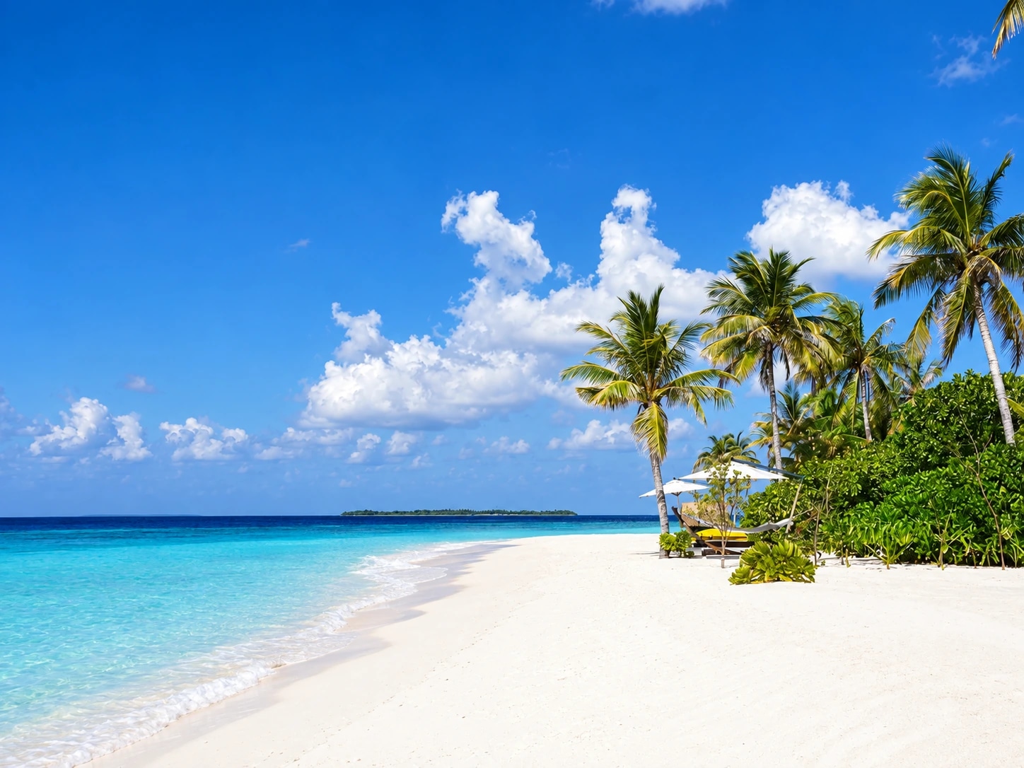 White-sand beach, palms and turquoise lagoon at Cheval Blanc Randheli